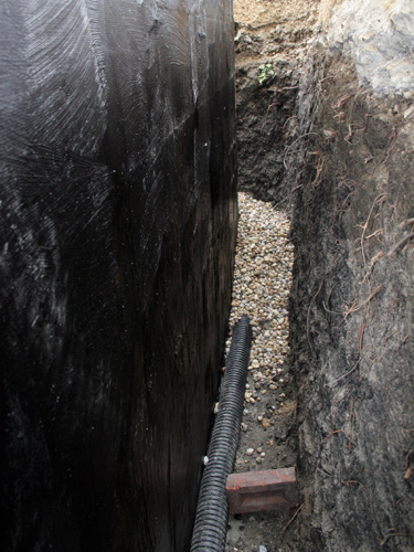 covering weeping tile with river stone